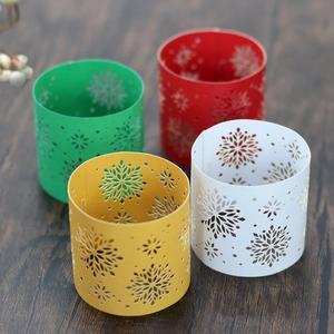 Set of four metal snowflake napkin rings in festive red, green, gold, and white colors