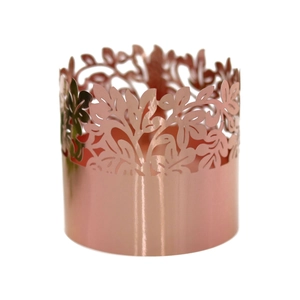 Close-up of rose gold laser-cut leaf pattern napkin ring with metallic hollow design