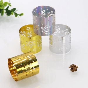 Detailed laser-cut snowflake napkin rings in gold and silver for festive table decor
