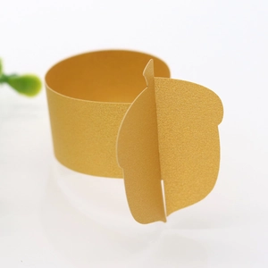 Detail of champagne gold acorn napkin ring made from high-quality pearlescent paper