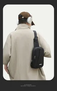 Detail view of a black tactical chest bag showing wide adjustable strap and buckle