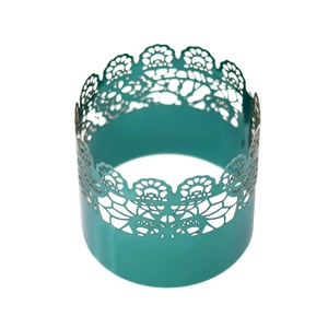 Detail of turquoise laser-cut lace napkin ring with intricate floral pattern for party