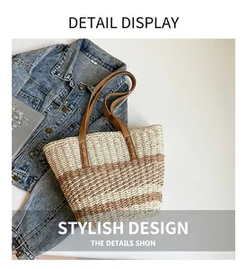 Detail view of woven straw tote bag with reinforced faux leather handles and cross stitching