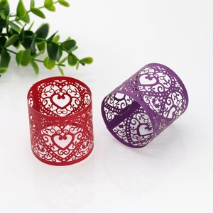 Close-up of laser-cut heart pattern napkin rings in red and purple paper