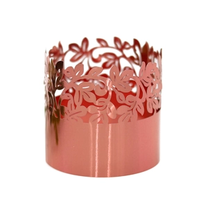 Macro detail of rose gold laser-cut floral pattern for festive cupcake wrappers and napkin rings