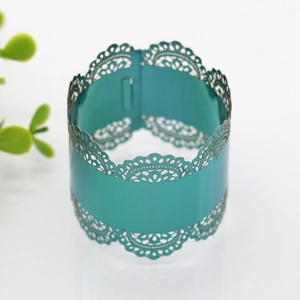 Close-up of laser-cut lace pattern napkin ring in teal for wedding table decor