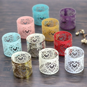 Detailed laser-cut heart patterns on colorful decorative napkin rings for weddings