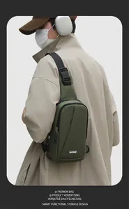 Detail of smart storage space in a dark green nylon sling bag for outdoor sports