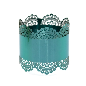 Detailed close-up of teal metallic napkin ring with intricate laser-cut lace patterns