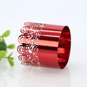 Macro detail of red metallic napkin ring with laser-cut hollow patterns for party decor