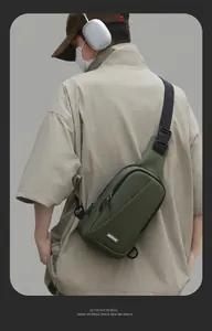 Outdoor model shot showing the back side and straps of the olive green crossbody chest bag