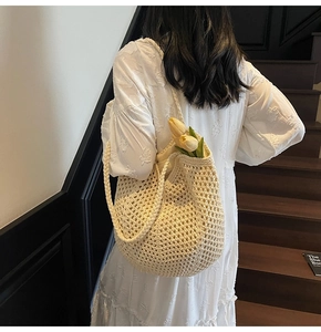 Macro view of woven hollow design and thick straps on beige shoulder crochet bag