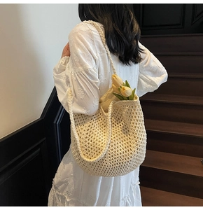 Detail of woven beige tote bag with hollow mesh pattern and elegant fabric lining