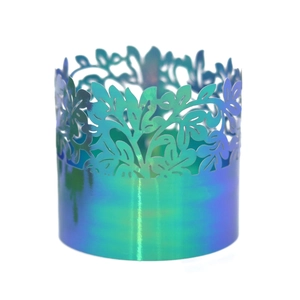 Close-up of laser-cut leaf pattern on iridescent gold party napkin ring with gradient finish