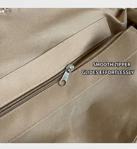 Detail of the smooth zipper closure and inner pocket lining of the woven tote bag
