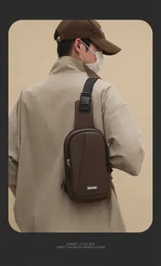 Brown nylon crossbody chest bag with adjustable strap shown on model during outdoor activities