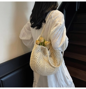 Close-up of cream woven tote bag with chunky crochet texture and large capacity