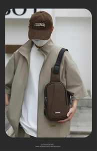 Outdoor close-up of a brown tactical chest bag with adjustable strap and buckle