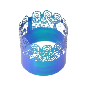 Close-up of laser-cut lace pattern on purple gradient metal wedding napkin ring