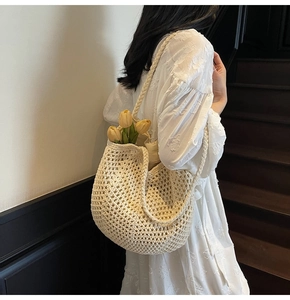 Detailed close-up of ivory woven crochet tote bag with hollow out grid pattern texture
