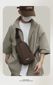 Detailed view of brown waterproof chest bag featuring adjustable strap and MACHUGE logo