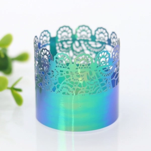 Detailed close-up of hollow laser-cut lace napkin ring in iridescent emerald gradient