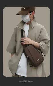Detail of dark brown men's chest bag with water-resistant fabric and adjustable strap