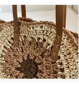 Close-up of contrast straw weaving pattern and sunflower embroidery on the beach tote bag