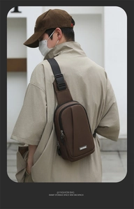 Deep brown chest bag for men showing adjustable shoulder strap in outdoor setting