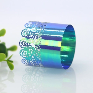 Macro detail of iridescent laser-cut lace napkin ring with vibrant metallic gradients