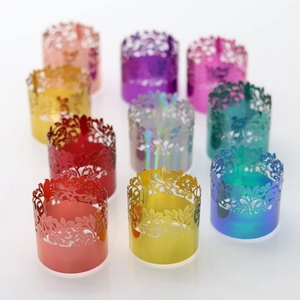 Close-up of laser-cut floral metal napkin rings in various metallic finish colors