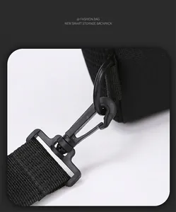 Detail of durable swivel hook and D-ring on high-density nylon shoulder strap of a black bag