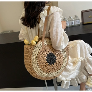 Detail of sunflower woven straw tote with leather handle and hollow circular design