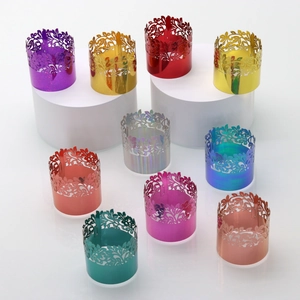 Close-up of laser-cut hollow floral napkin rings in various shiny metallic colors