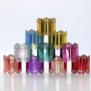 Lace-cut napkin rings in multiple metallic colors like gold and purple for festive decor