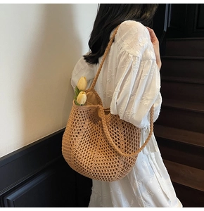 Detail view of woven crochet tote bag with large hollow mesh texture and shoulder strap