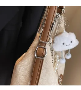 Detail of adjustable brown leather strap and weave texture on large tote bag