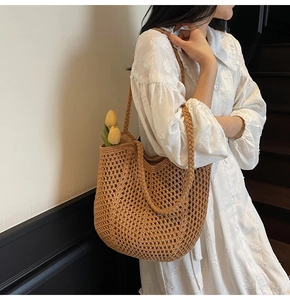 Detail of hand-woven hollow knit tote bag with thick braided shoulder straps in brown