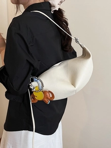 Chic cream hobo shoulder bag with litchi grain texture and brown elephant charm