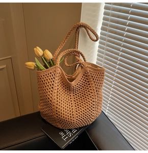 Detailed macro view of hollow mesh crochet pattern on a brown woven beach tote bag