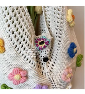Detail of multi-color floral knit beach tote featuring a strong magnetic closure buckle
