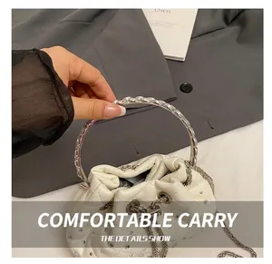 Close-up of quilted white leather bucket bag with rhinestone-encrusted silver ring handle