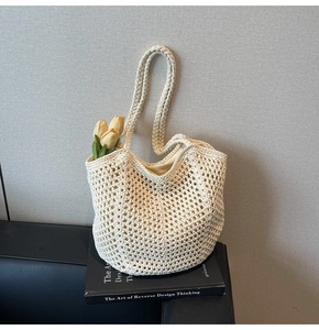 Detailed macro view of cream hand-woven crochet tote bag with hollow mesh texture
