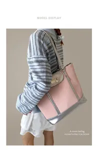 Detail of pink tote bag with wood texture and silver metallic trim on a female model