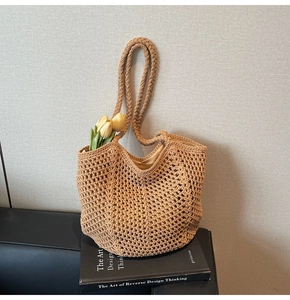 Detail of hollow woven tote bag with fabric lining on a leather sofa for summer vacation