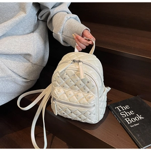 Chic quilted mini backpack in cream PU leather featuring rhinestone accents on stairs