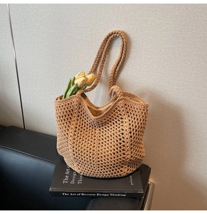 Detailed close-up of a brown crochet hollow tote bag featuring braided handles and mesh texture