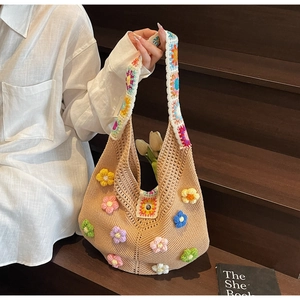 Detail of colorful hand-crocheted floral tote bag with 3D flower patterns and ethnic style