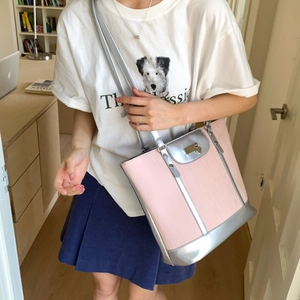 Detail of pink textured tote bag with silver leather trim and heart-shaped metal lock