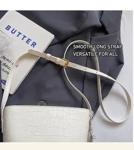 Detailed top view of white crocodile pattern mini bucket bag with adjustable strap